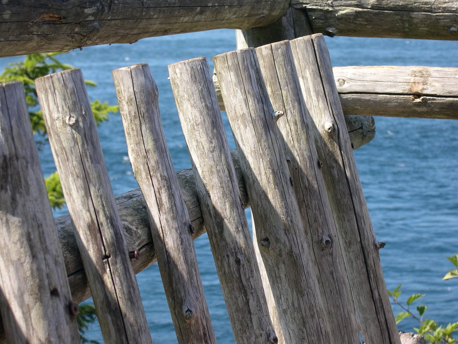 Rough wood railing enclosing observation deck overlooking ocean at Cape Flattery WA