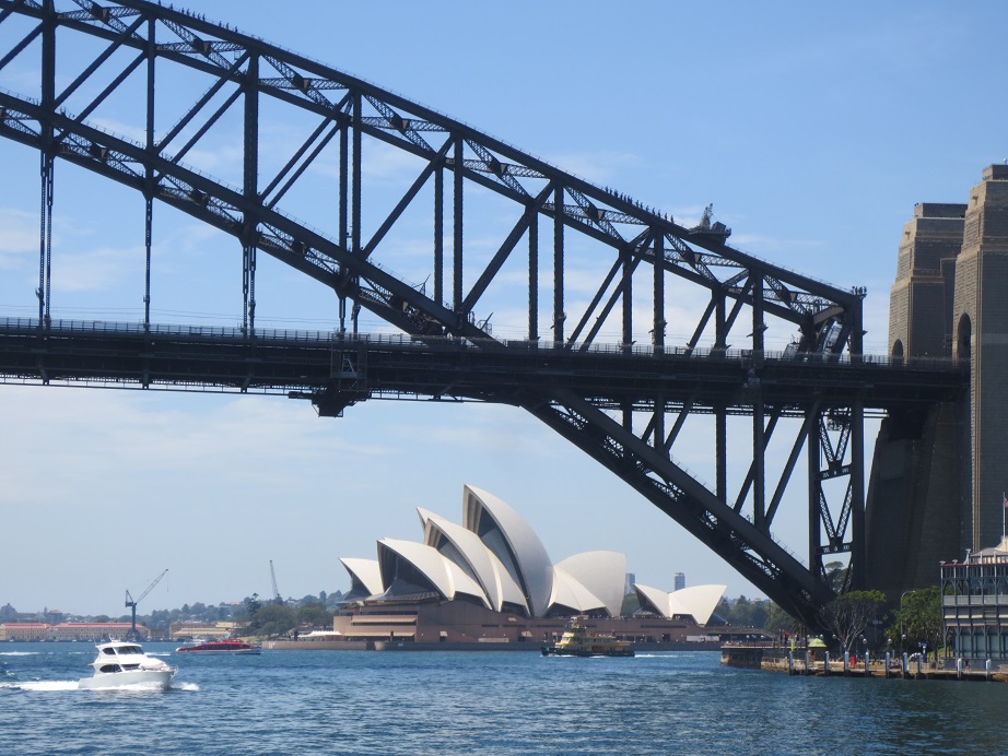 One arc of Sydney Harbour Bridge, framing the iconic Opera House in the distance.
