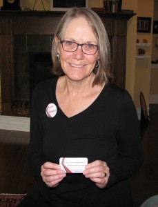 Isabel Gibson with campaign button and business card.