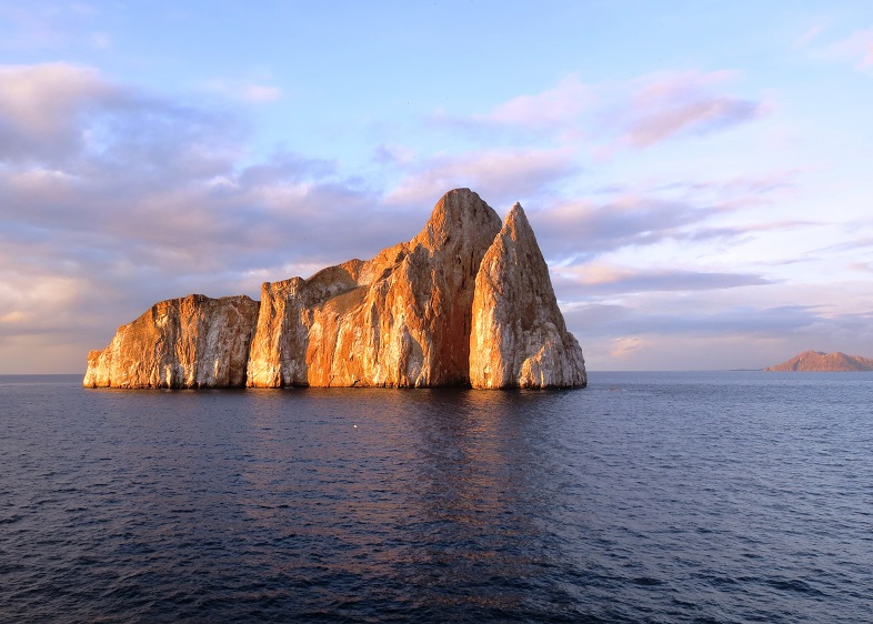 Rocky islet in Galapagos, lit by sunset.
