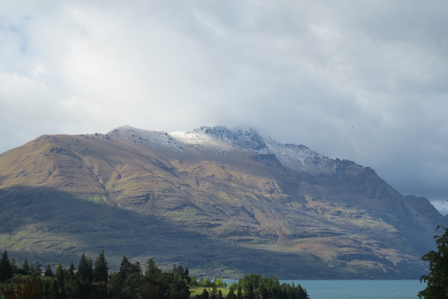 Early morning lights a mountain over a lake at Queenstown NZ.