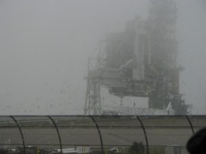 Picture of some launch infrastructure out a rain-streaked bus window.