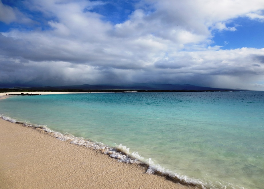 Horseshoe bay with blue-green water and impending storm clouds