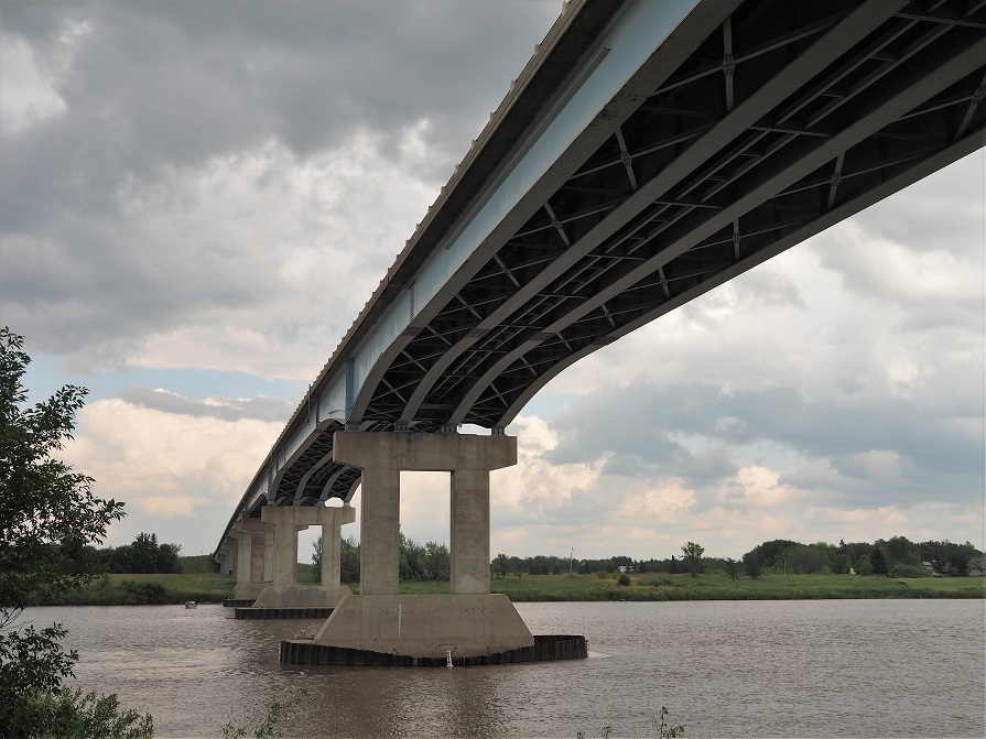 Cement pillar bridge across Red River, seen from underneath the bridge.