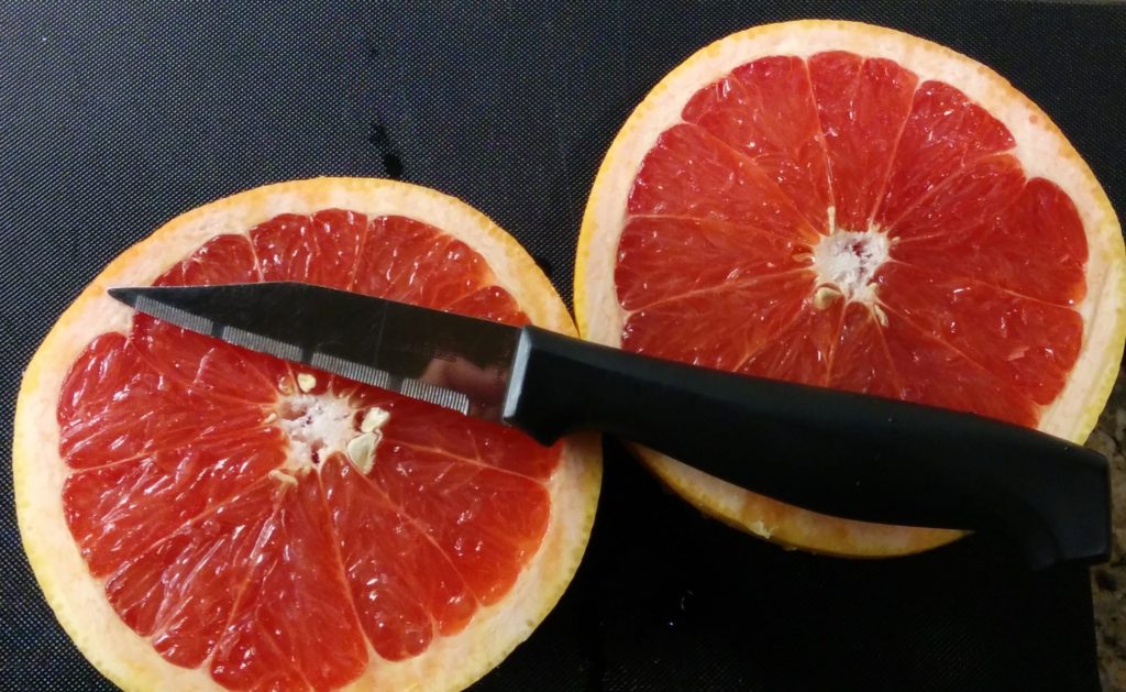 Two halves of a red grapefruit.