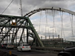 Old Walterdale Bridge with arch of replacement bridge in background.