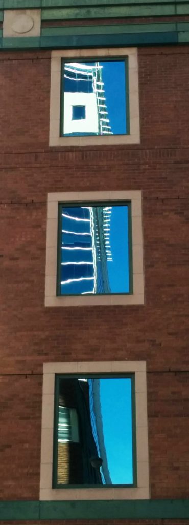 Fun-house style reflections in three office windows