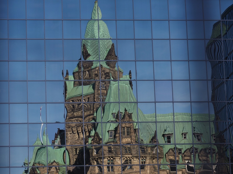 West Block reflection in office building across the street.