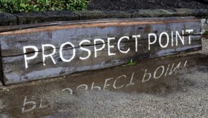 Prospect Point's wetahered sign and its reflection.