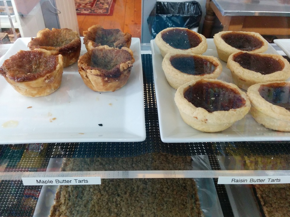 Bakery shelf with maple and raisin butter tarts.