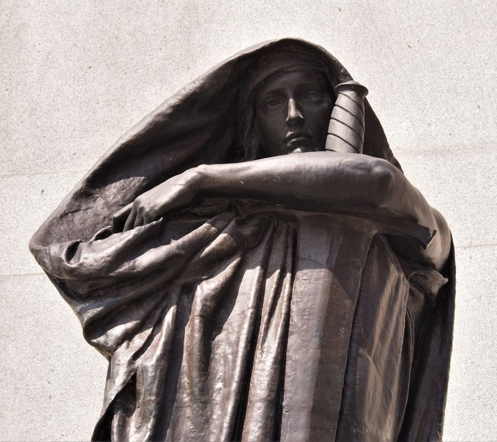 Close-up of bronze statue of Justice, in front of Supreme Court of Canada.