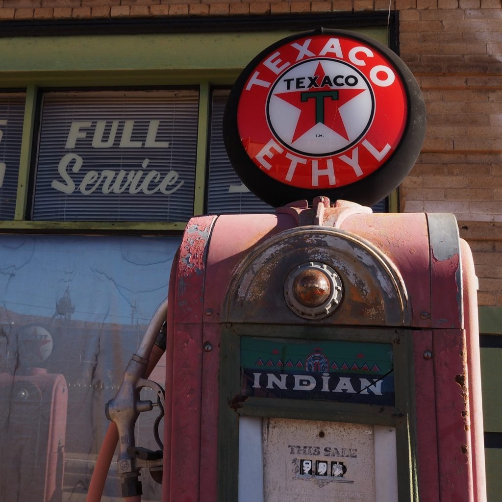 Old gas pump with new Texaco sign on top.