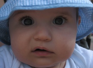 Close-up of baby with uncomprehending look on face.