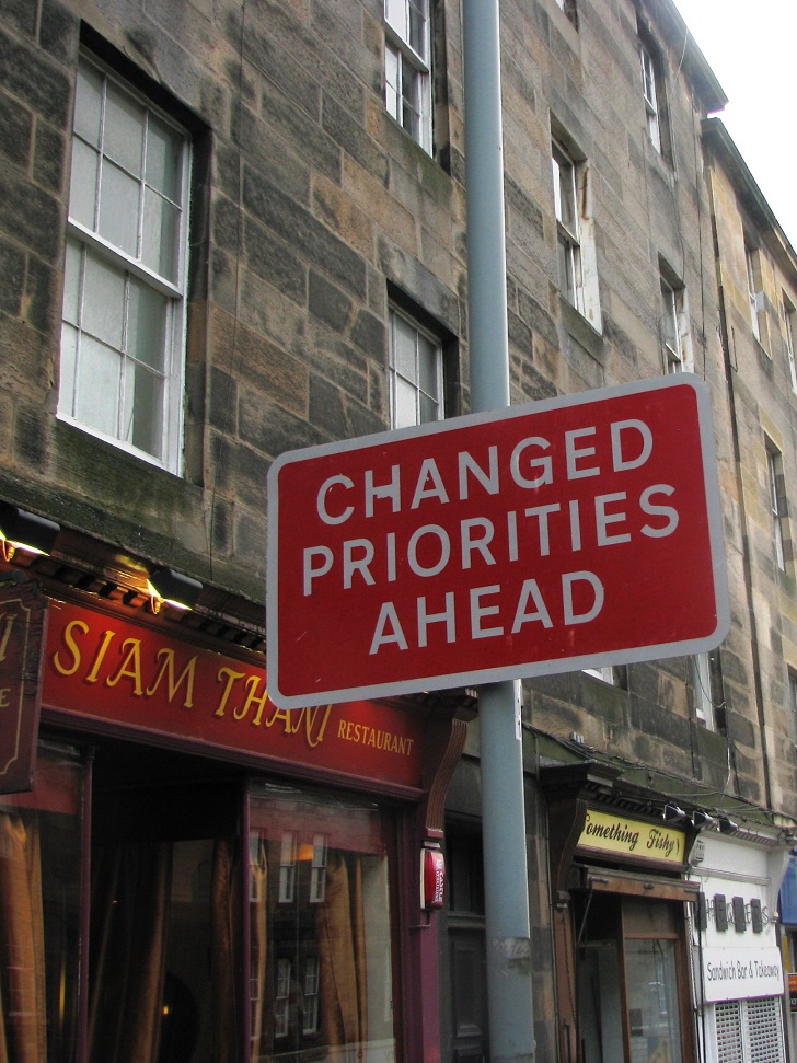 Red and white traffic sign in Edinburgh: Changed Priorities Ahead