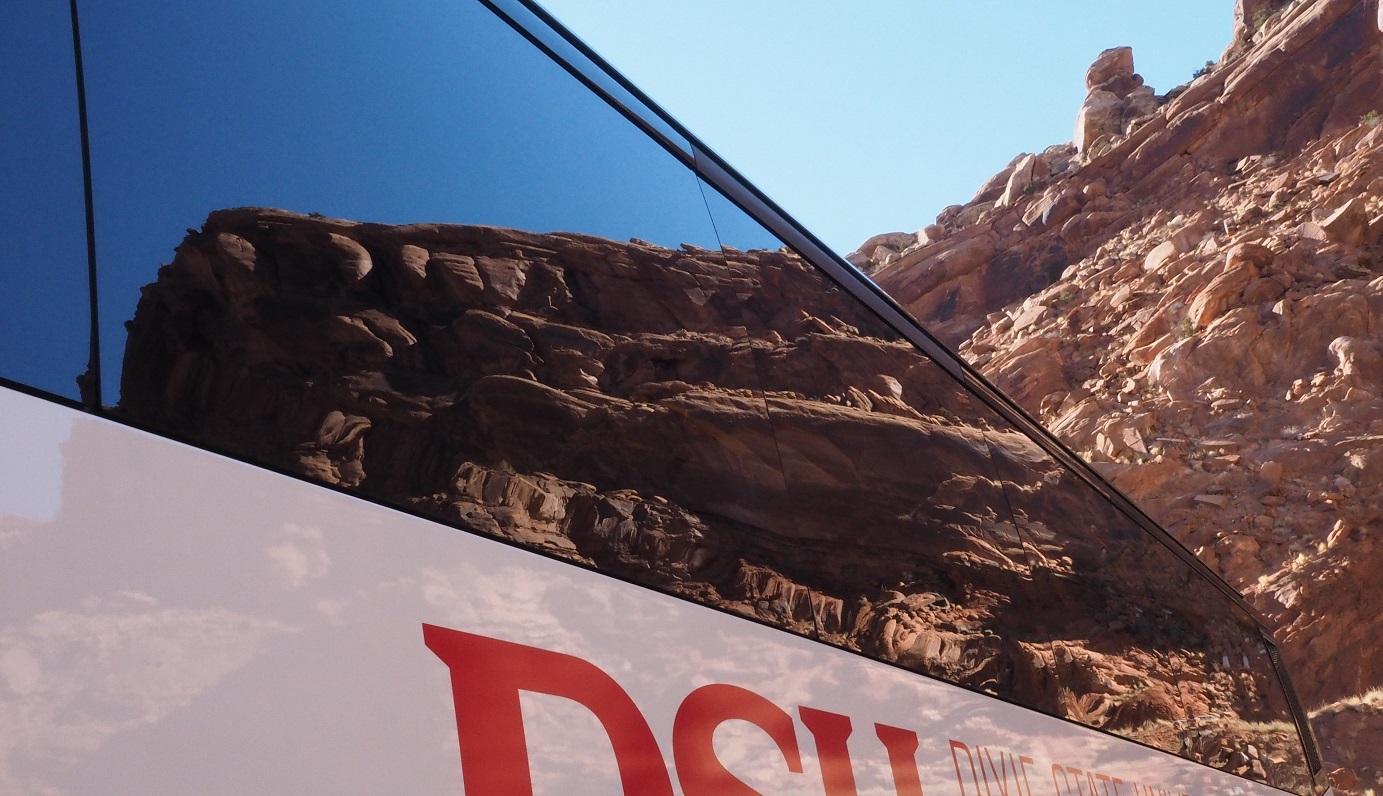 Rock formation reflected in bus window