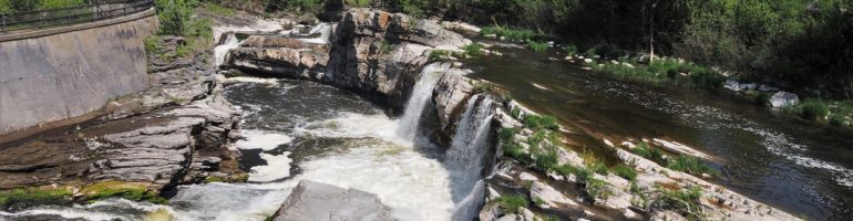 Rocky outbreak forming Hogsback Falls, near locks on Rideau River.