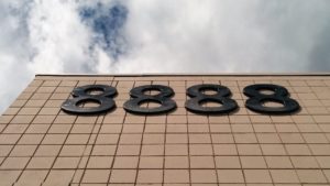 Four metal 8s on a tile wall.