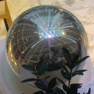Atrium walls reflected in silver ball.