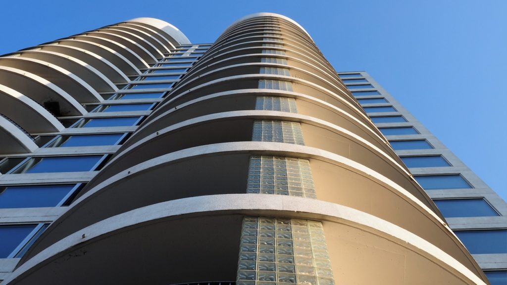 Shot of condo tower taken right at base of building, looking up