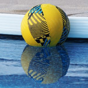 Blue and yellow ball reflected in pool.