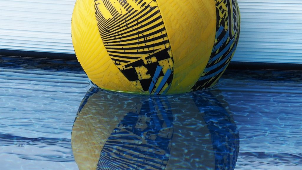 Cropped close-up of pool ball and its reflection.