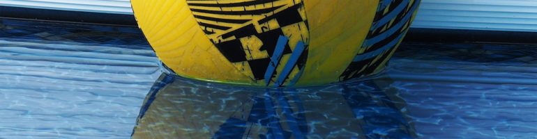 Cropped close-up of pool ball and its reflection.