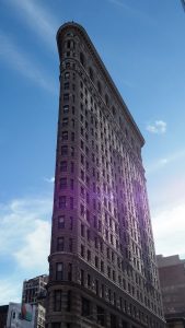 Wide-angle but vertical shot of iconic Flatiron Building, NYC.