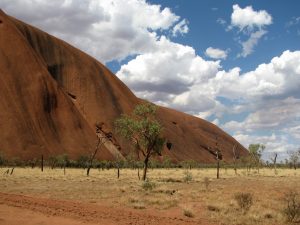 View of one end of Uluru (Ayer's Rock) with desert in foreground.