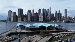 Brooklyn Bridge Park in foreground, with East River and Manhattan skyline in background