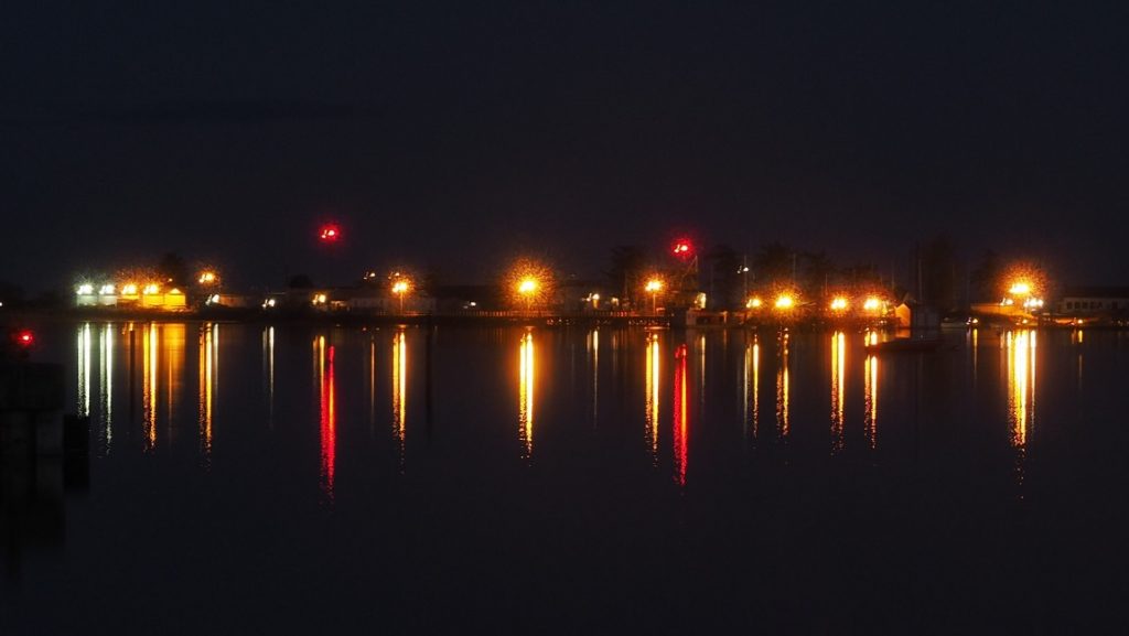 Coloured lights reflected in water of Comox Harbour.
