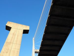 Street-level view of bridge with concrete pier from original bridge.