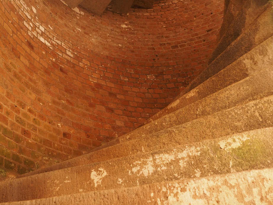 View looking up circular slate stairwell in fort.