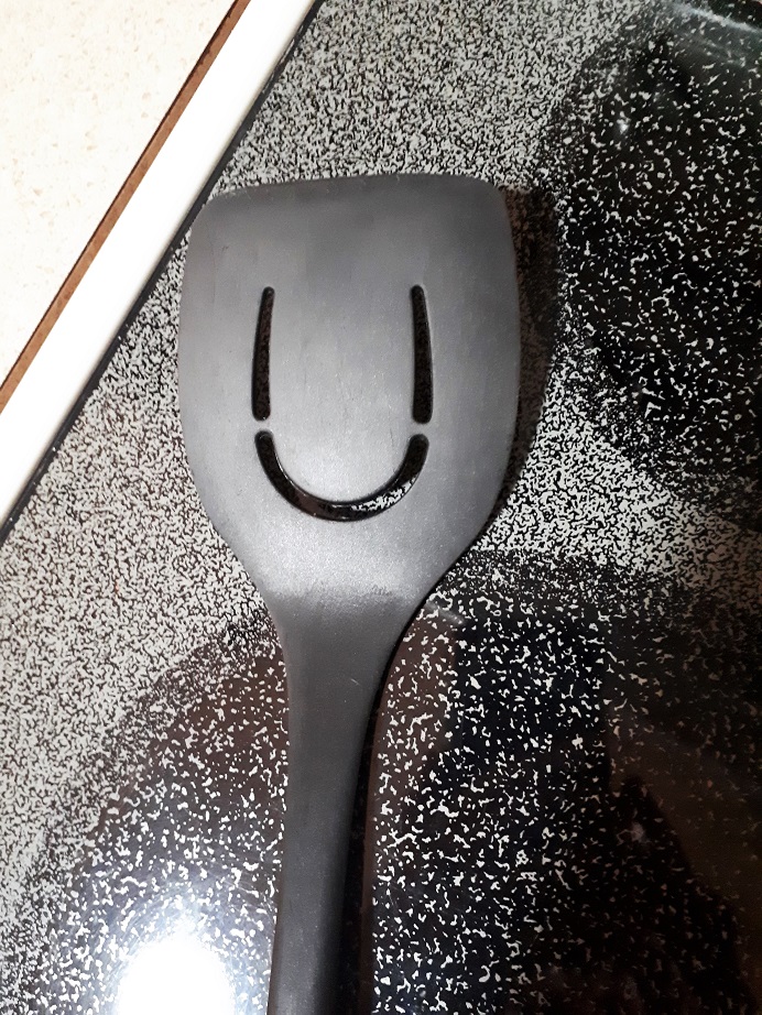 Smiley face discovered on plastic spatula.