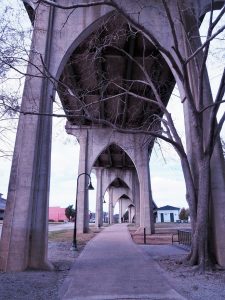 Soaring arches form the support for a road overhead.