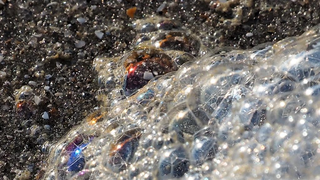 Colourful froth on the beach