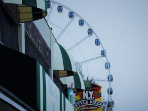 Small arc of Myrtle Beach Skywheel visible past streetfronts