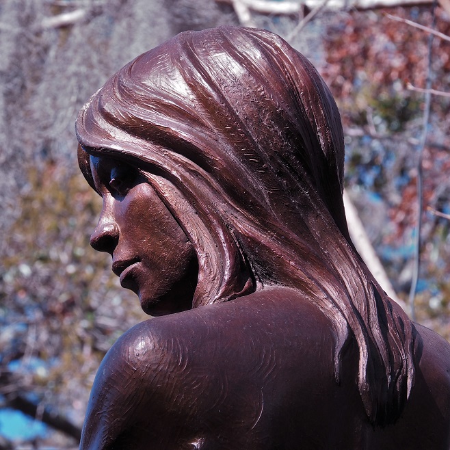 Close-up of head of bronze of girl