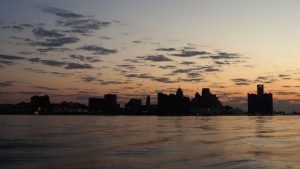 Detroit skyline in silhouette at sunrise.