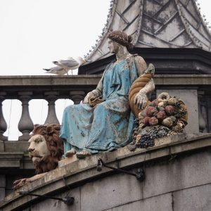 Paint flaking off statues on building