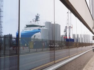 Aberdeen dock infrastructure reflected in office window