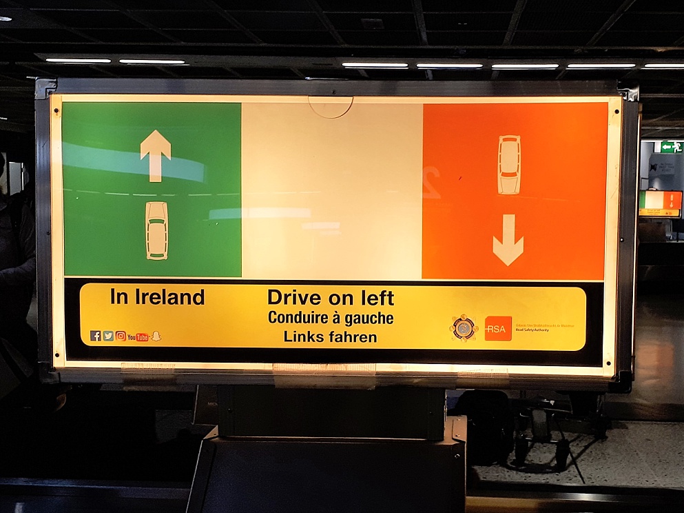Airport sign advising international visitors to drive on the left