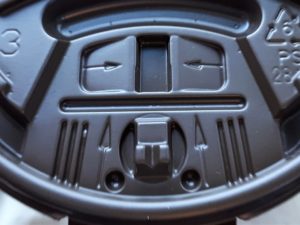 Face on coffee-cup lid