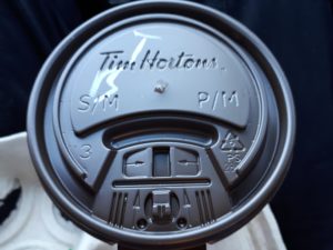 Face seen on lid from Tim Hortons coffee cup