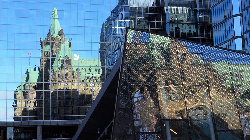 Reflections of West Block in two buildings