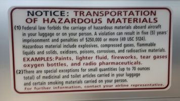 Sign warning about hazardous materials not allowed on airplanes.