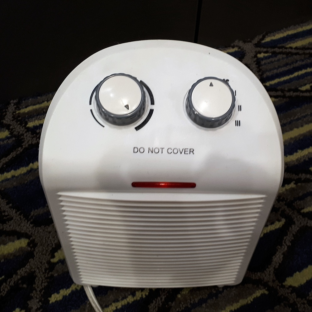 Accidental face on a space heater,made by two dials and an "On" light