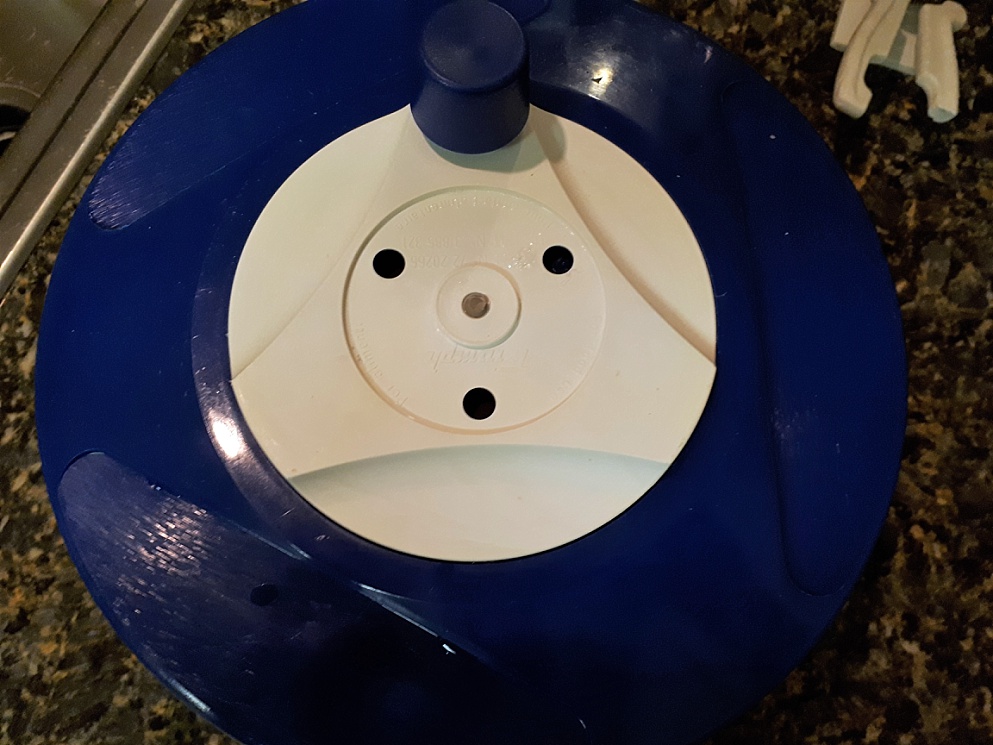 Face on top of salad spinner