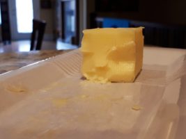 Face chiselled out of butter stick
