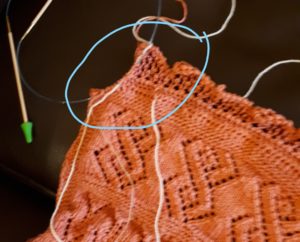 Showing the last bit to be knit on a large shawl.