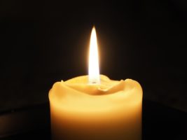 Candle against black background